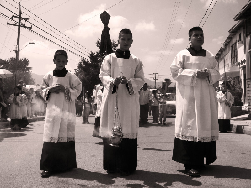 Ministranti kráčí o Velkém pátku z periferie města směrem do centra města. La Ceja, Kolumbie.